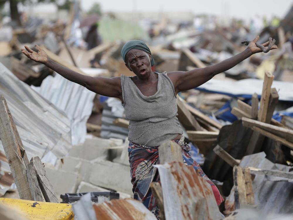 A woman gestures in front of her demolished house in Otodo-Gbame waterfront in Lagos, Nigeria. Saturday, March 18, 2017. Slums and shantytowns are often targeted in rampant demolitions across Africa's most populous country