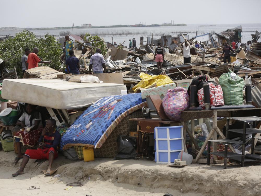 Residents salvage objects from houses demolished by government officials in Otodo-Gbame waterfront in Lagos Nigeria, Saturday, March 18, 2017.