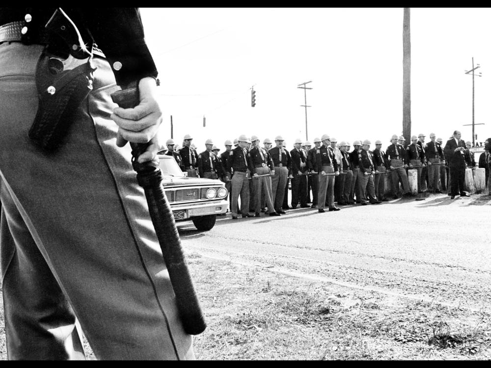 Alabama state troopers form a roadblock on the far side of the Edmund Pettus Bridge.