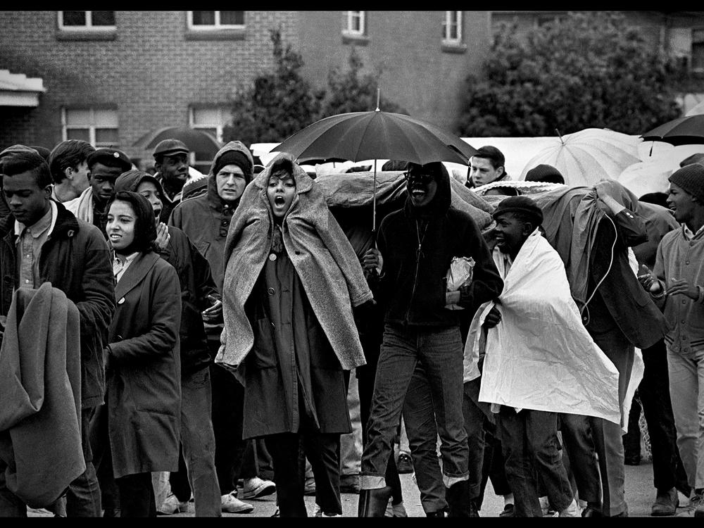 Songs provide strength amid the rain as students protest in Selma after Bloody Sunday.<br>