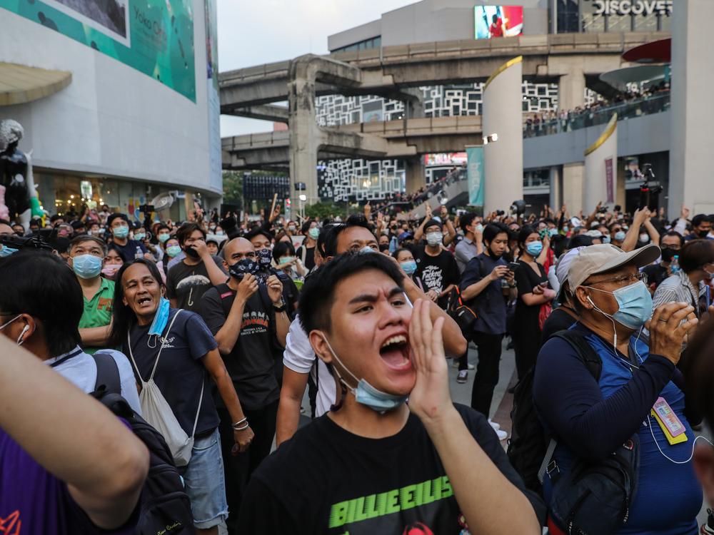 Thai protesters cheer during a pro-democracy rally at the Pathumwan Intersection on Feb. 10, 2021, in Bangkok, Thailand. Protesters descended on a shopping mall in central Bangkok to stage a 