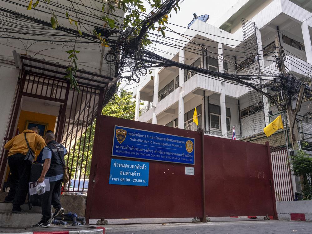 Police enter an immigration detention centre in Bangkok on Jan. 22.