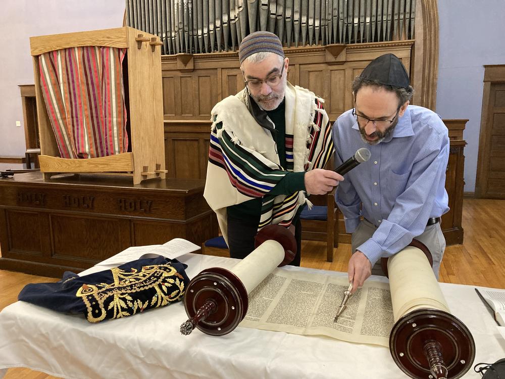 Sholom Sandalow reads from the Torah as Rabbi Brant Rosen watches on a Saturday morning Shabbat service with Tzedek Chicago, an anti-Zionist congregation.