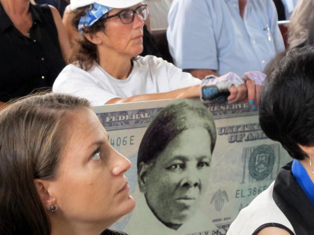 A woman holds a sign supporting Harriet Tubman for the $20 bill during a town hall meeting at the Women's Rights National Historical Park in Seneca Falls, N.Y., on Aug. 31, 2015.