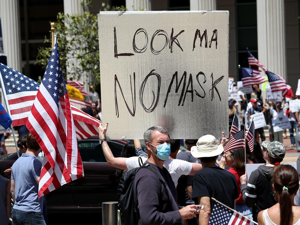 <strong>May 1, 2020: </strong>Activists  in San Diego hold signs and protest the California lockdown due to the COVID-19 pandemic.