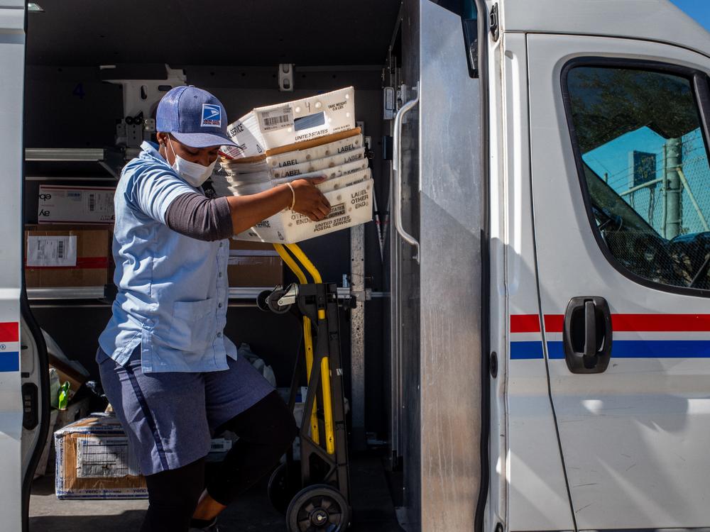 A U.S. Postal Service employee unloads mail at a facility in 2022 in Houston.
