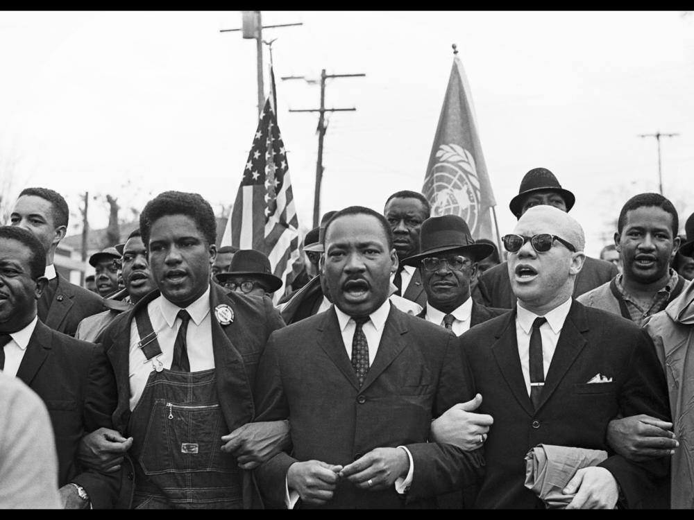 (From left) Rev. Ralph Abernathy, James Forman, Dr. Martin Luther King Jr. and Rev. Jess Douglas lead the voting rights march to the Montgomery County Courthouse.