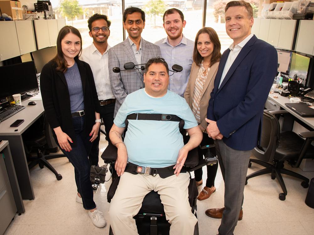 Keith Thomas, who lives with paralysis, poses with the research team at Northwell Health's Feinstein Institutes for Medical Research that worked with him for months to restore lasting movement and feeling in his arm and hand. The 'double neural bypass' system uses brain implants and artificial intelligence to allow signals to and from Thomas' brain to bypass the site of his injury.