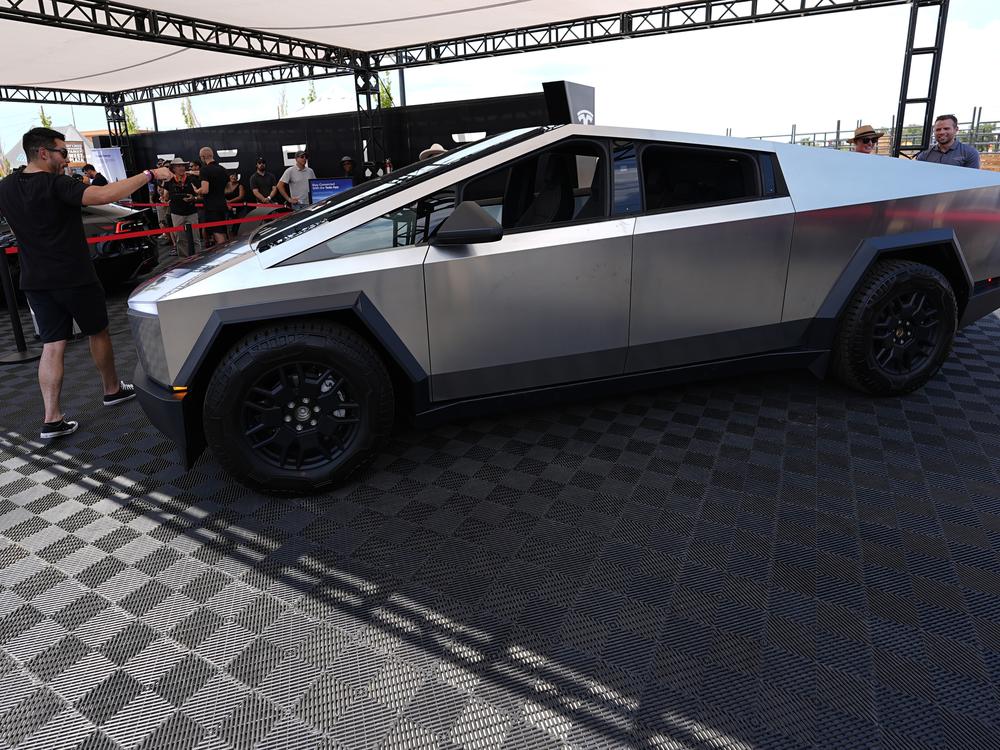 Visitors look over a 2024 Cybertruck in the Tesla display at the Electrify Expo, last July.