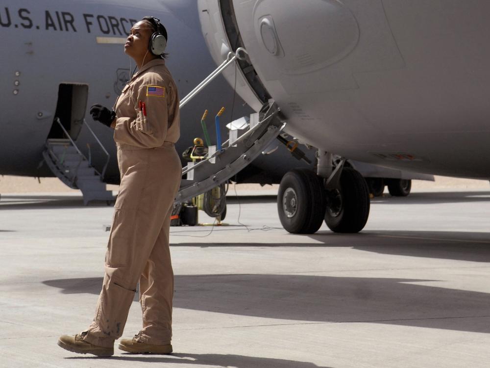 Staff Sgt. Krysteena Scales, a 816th Expeditionary Airlift Squadron Flying Crew Chief, performs pre-flight checks before departing on a mission in a C-17 Globemaster III in 2009.