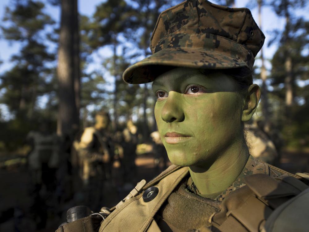 Pfc. Christina Fuentes Montenegro prepares to hike to her platoon's defensive position during patrol week of Infantry Training Battalion near Camp Geiger, N.C., in 2013.