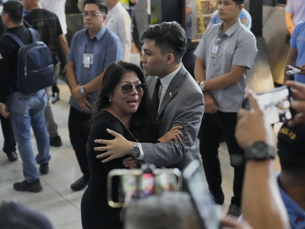 A supporter of former President Rodrigo Duterte reacts upon finding out he was arrested, at the airport in Manila, Philippines, Tuesday, March 11, 2025.