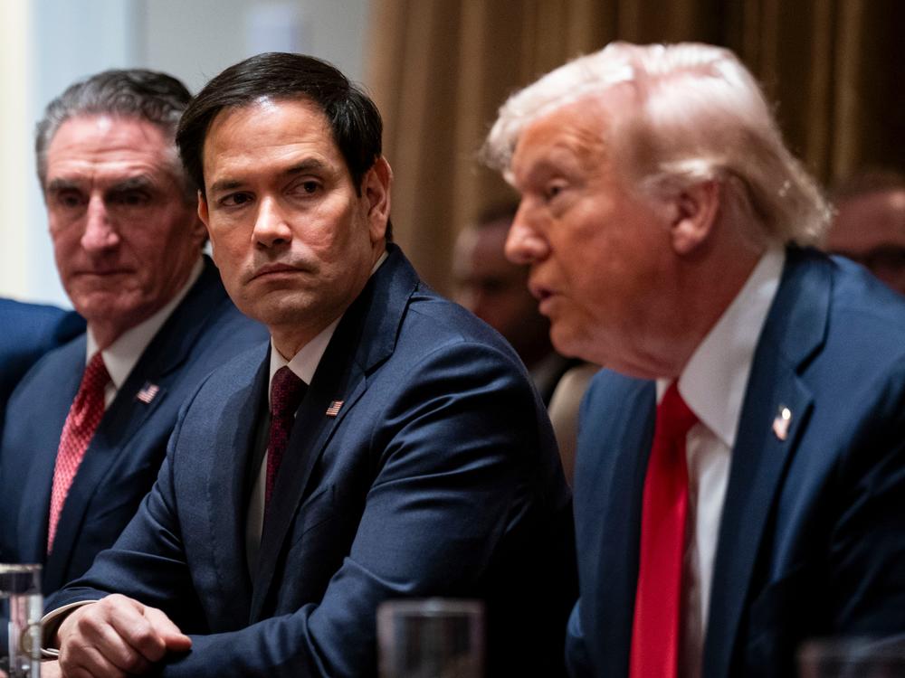 Secretary of State Rubio (center) flanked by Doug Burgum, secretary of the interior, and President Donald Trump during a cabinet meeting on Feb. 26. On Monday, Rubio posted on X that 83% of USAID contracts had been canceled following a review.