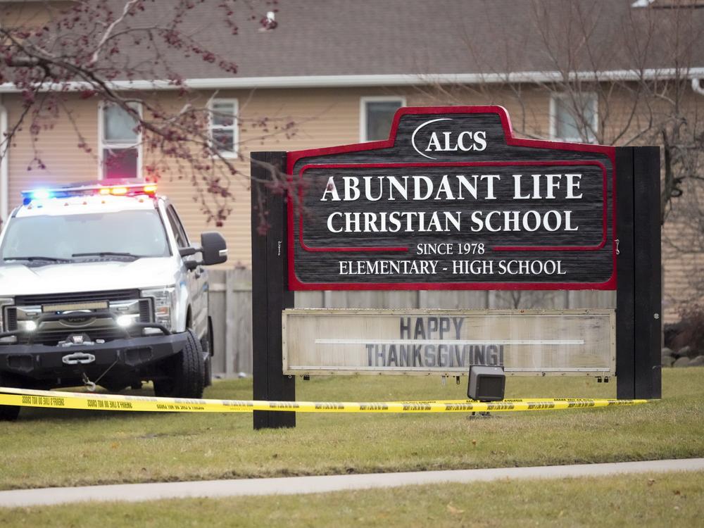An emergency vehicle is parked outside the Abundant Life Christian School in Madison, Wis., following a shooting on Dec. 16.