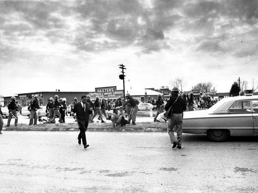 Hosea Williams, left, who led a march in Selma, Ala., leaves the scene as state troopers break up the demonstration on what is known as Bloody Sunday on March 7, 1965.