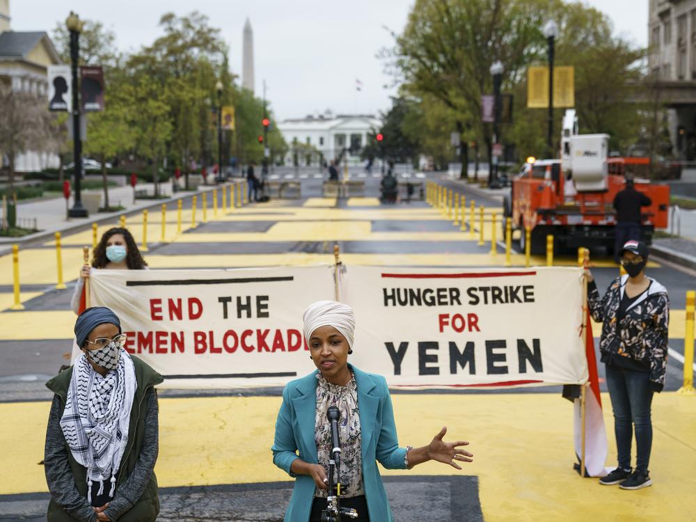 With Iman Saleh (left), on her 12th day of a hunger strike for Yemen, looking on, Rep. Ilhan Omar, D-Minn., speaks during a press conference at Black Lives Matter Plaza calling for an end to U.S. support for a Saudi Arabia-led blockade of Yemen on April 9, 2021.