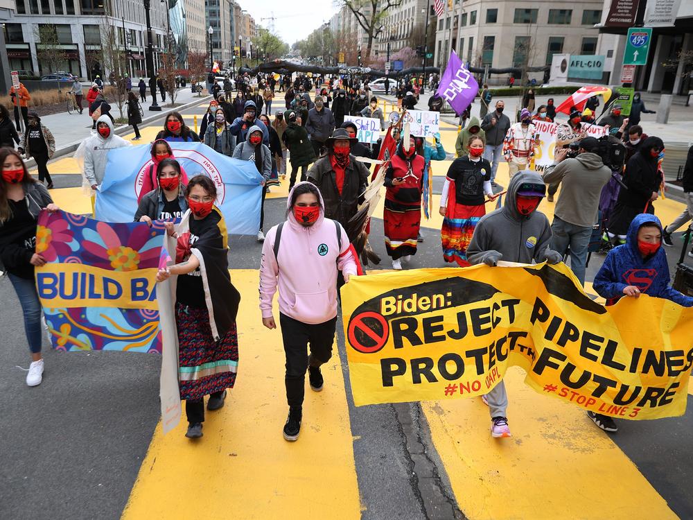 Indigenous environmental activists march through Black Lives Matter Plaza on their way to the White House as part of a protest against oil pipelines on April 1, 2021.