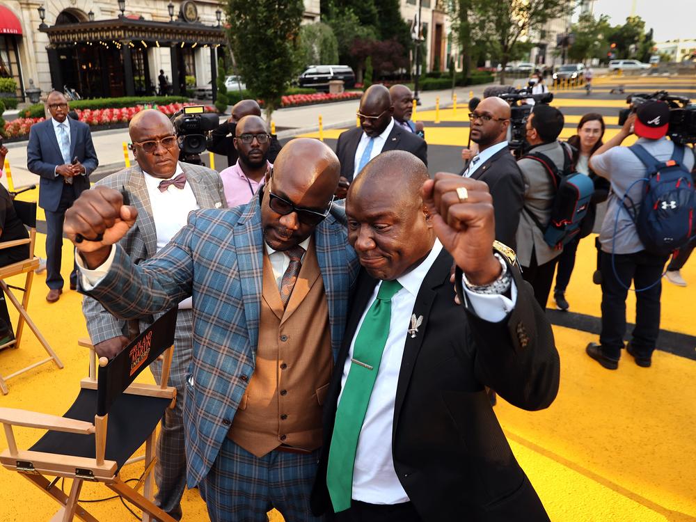 Philonise Floyd (left), George Floyd's brother, embraces Floyd family attorney Ben Crump as the family visits Black Lives Matter Plaza on on May 25, 2021, the one-year anniversary of George Floyd's death.
