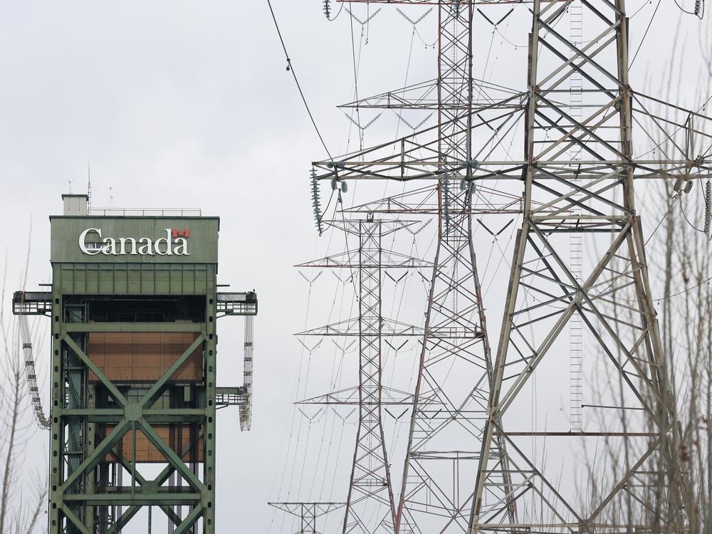 Power lines run near a bridge in Hamilton, Ontario, on Feb. 4. This week, Ontario's leader threatened a surcharge on Canadian electricity sold in some U.S. states in retaliation for President Trump's tariffs.