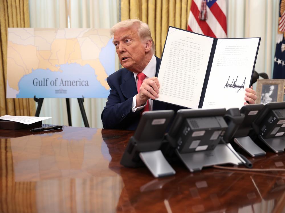 President Trump signs executive orders in the Oval Office on March 6, including the order terminating the security clearances of those who work at the law firm Perkins Coie.