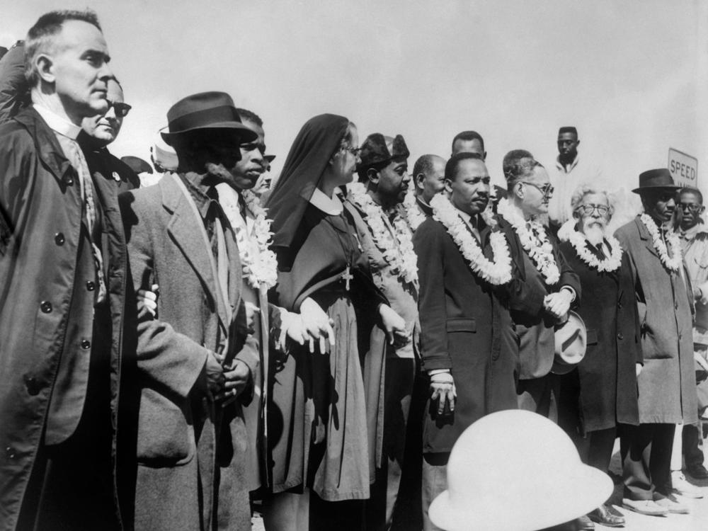 Civil rights demonstrators, led by Dr. Martin Luther King (5th R), civil rights activist Ralph Abernathy (5th L), John Lewis (3rd L) and other civil and religious leaders, make their way from Selma to Montgomery on March 22, 1965 in Alabama.