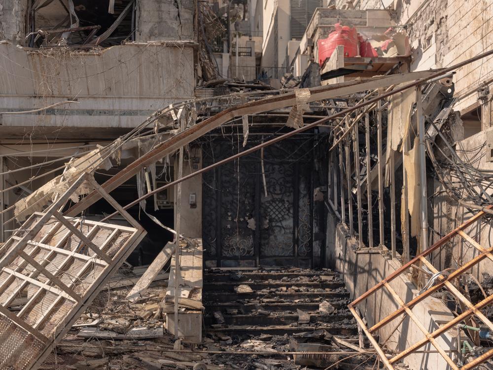 The apartment building was in an upscale neighborhood with well-kept buildings and large gardens in north Damascus.