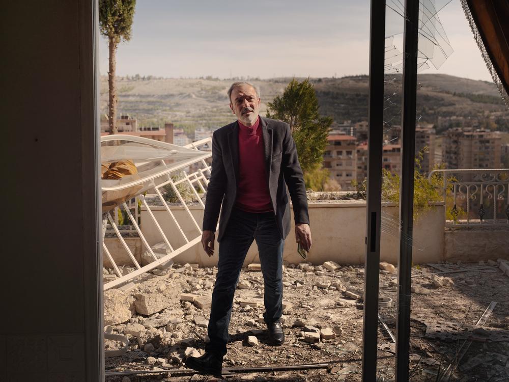 Ghassan Mamouli, a representative from the Damascus government, inspects the damage at the site of an Israeli airstrike on Thursday.