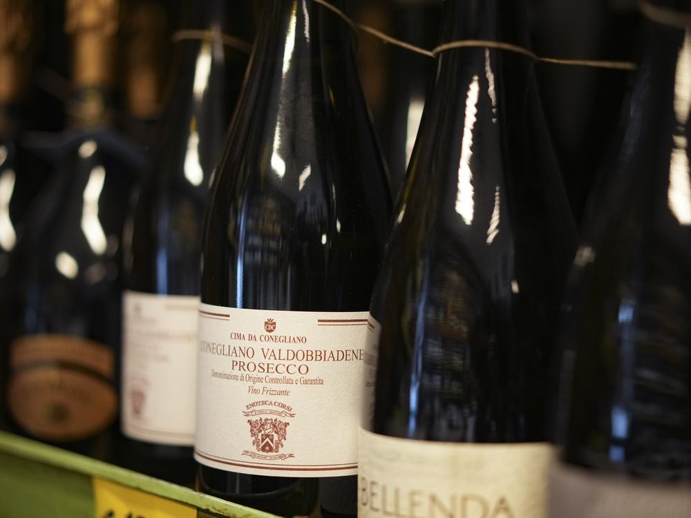 Bottles of Prosecco are lined up on a shelf of a wine shop in Rome last month. Trump's threatened 200% tariffs, if they go into effect, could impact products like imported Prosecco, French champagne and Spanish wine.