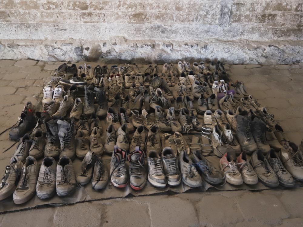 This photo released by the Jalisco State Attorney General's Office shows shoes at the Izaguirre Ranch where skeletal remains were also discovered in the municipality of Teuchitlan, Mexico on Tuesday.