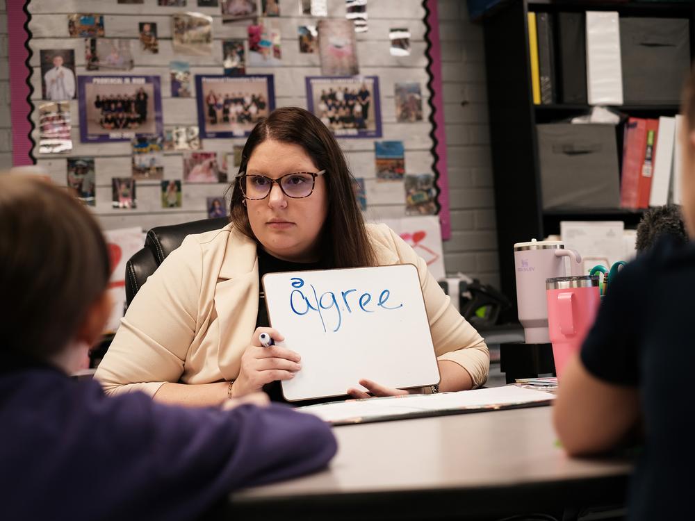 Second grade teacher Cady Caskey works with a small group of students on words that include 