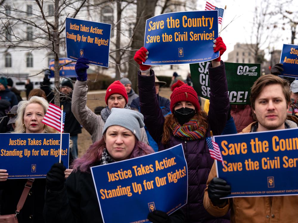 People hold signs during a 