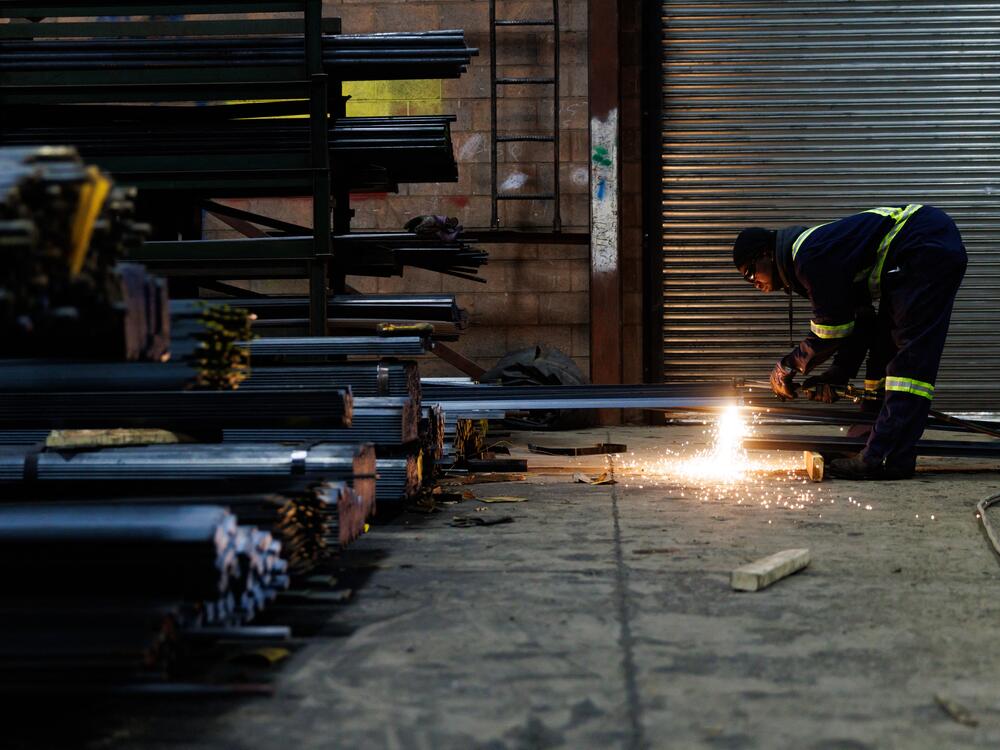 A worker cuts a piece of steel for a customer at North York Iron, a steel supplier in Toronto, Ontario, Canada, Feb. 11.