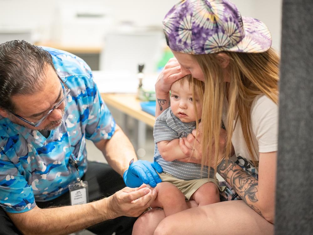 One year-old River Jacobs is held by his mother, Caitlin Fuller, while he receives an MMR vaccine from Raynard Covarrubio, at a vaccine clinic put on by Lubbock Public Health Department on March 1, 2025 in Lubbock, Texas. Cases of Measles are on the rise in West Texas as over 150 confirmed case have been seen with one confirmed death.