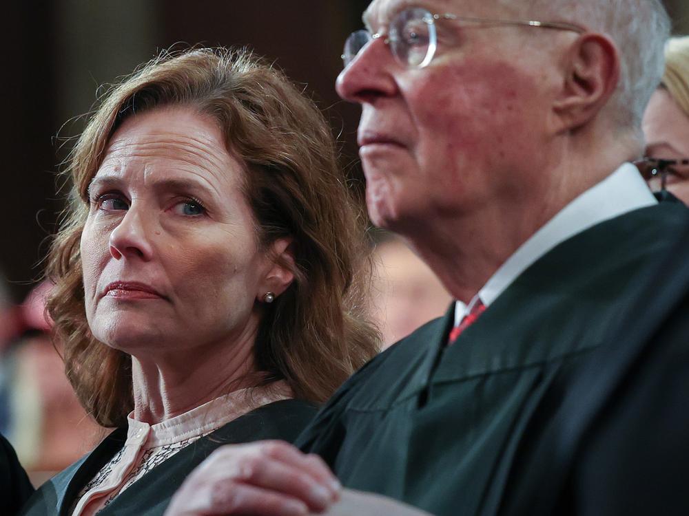 Supreme Court Justice Amy Coney Barrett and retired Supreme Court Justice Anthony Kennedy listen as President Trump addresses a joint session of Congress at the U.S. Capitol on March 4.