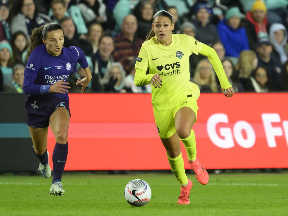 Orlando Pride defender Kerry Abello (left) and Washington Spirit forward Trinity Rodman chase after the ball during the first half of the NWSL championship at CPKC Stadium in Kansas City, Mo. on Nov. 23, 2024.