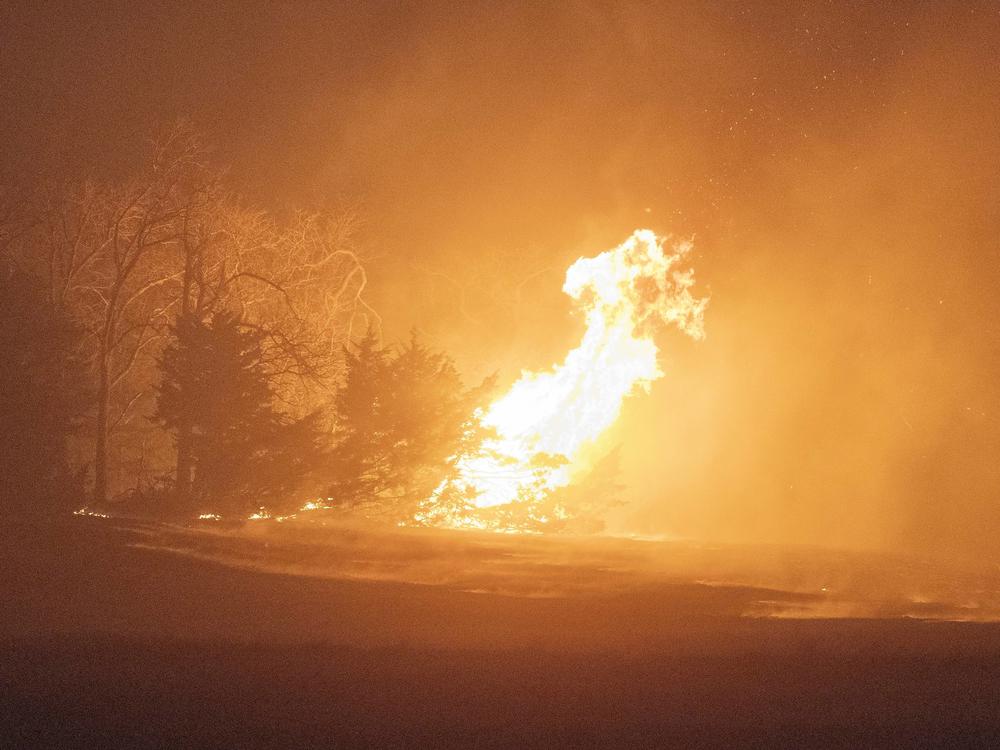 A wildfire burns at night on Friday, March 14, 2025, south of Langston, Okla.