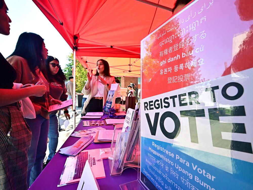 Potential young voters get information at a voter registration desk at California State University, Los Angeles, on Oct. 22, 2024. The Republican-backed SAVE Act would add documentary proof-of-citizenship requirements to voter registration.