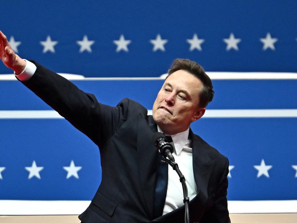 Elon Musk salutes as he speaks during an inaugural event in Washington, DC, on Jan. 20, 2025.
