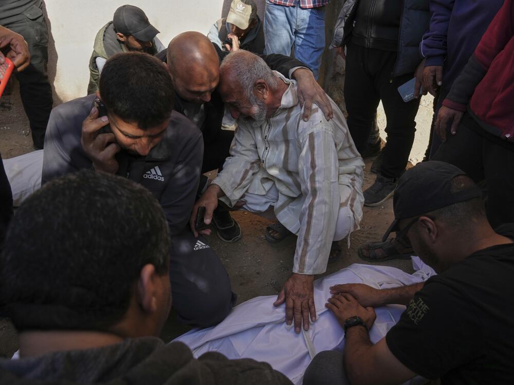 Palestinians mourn over the bodies of their relatives killed by an Israeli airstrike in Beit Lahiya, northern Gaza Strip on Saturday. The Israeli military says it was targeting 