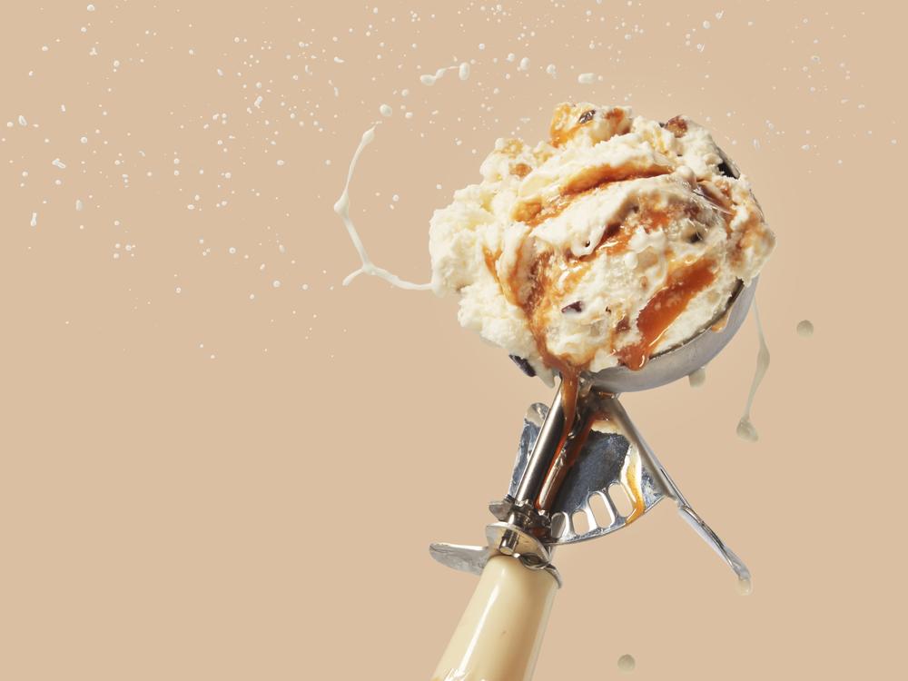 salted caramel scoop of ice cream flinging from scooper