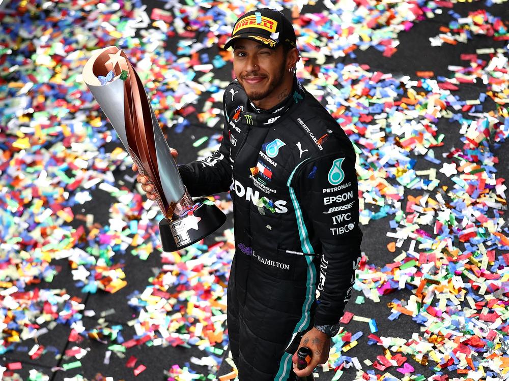 Race winner Lewis Hamilton of Great Britain and Mercedes GP celebrates winning a 7th F1 World Drivers Championship on the podium during the Grand Prix of Turkey on November 15, 2020 in Istanbul.
