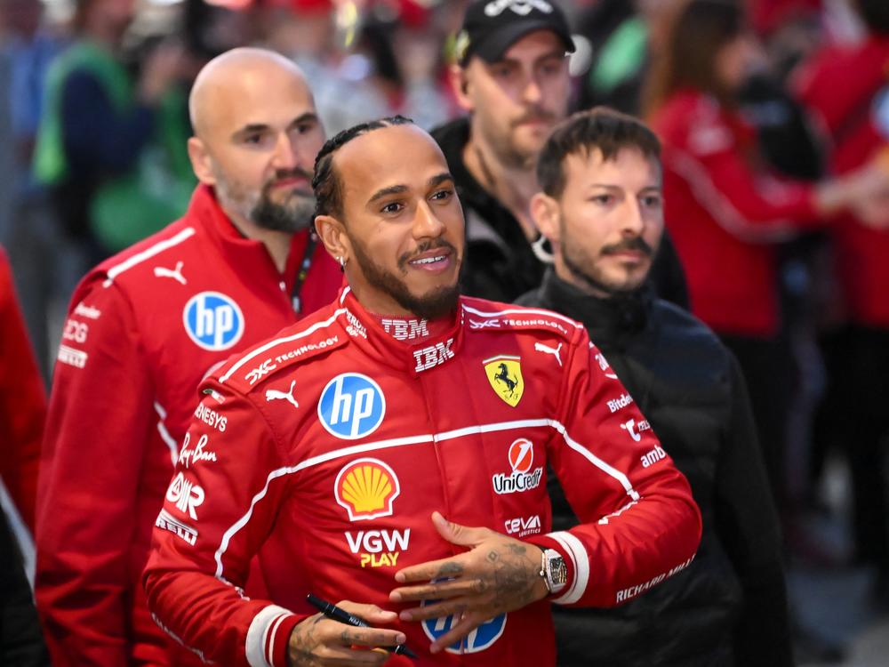 British F1 driver Lewis Hamilton signs autographs during the Ferrari Drivers' presentation event in Piazza Castello in Milan, Italy, on March 6, 2025. For the first time in a dozen years, Hamilton has a new team as he aims to return his F1 winning ways.