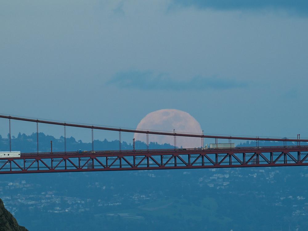 A full blood moon rises over the Golden Gate Bridge in San Francisco, Calif.