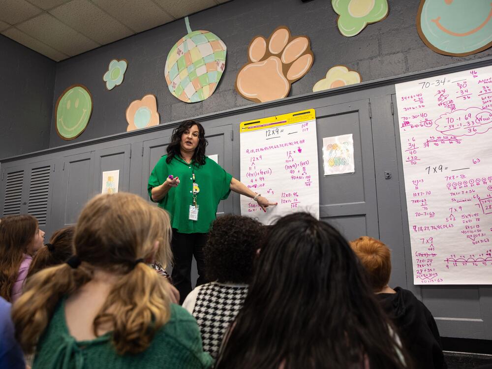 Third grade teacher Tracy Butts asks her students at Henagar Junior High School (K-8) how many different ways they can solve 12 x 9 without using pencil or paper. Together, they come up with five different possibilities.
