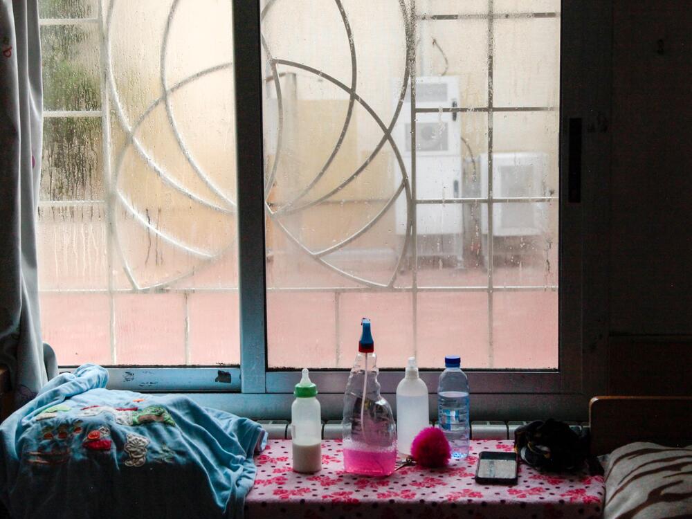 Bottles, disinfectant and water on a table near a cot in an orphanage in the Syrian capital Damascus. Many children of female detainees were sent to orphanages during the Assad regime. Some were never reunited with their parents.