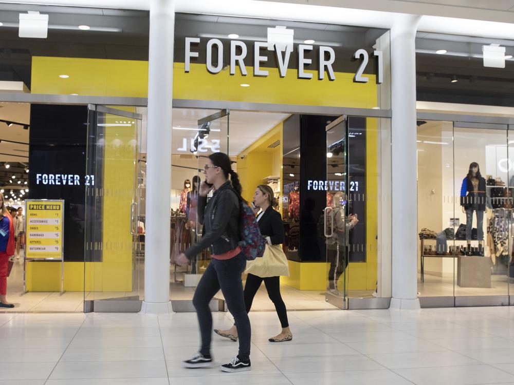 People walk in front of a Forever 21 clothing store in New York.