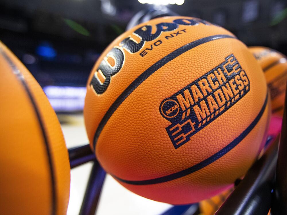 A basketball with a March Madness logo rests on a rack before a First Four game between Illinois and Mississippi State in the NCAA women's basketball tournament Wednesday, March 15, 2023, in South Bend, Ind.