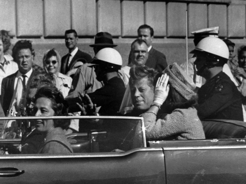 President John F. Kennedy is seen riding in his motorcade approximately one minute before he was shot in Dallas on Nov. 22, 1963.