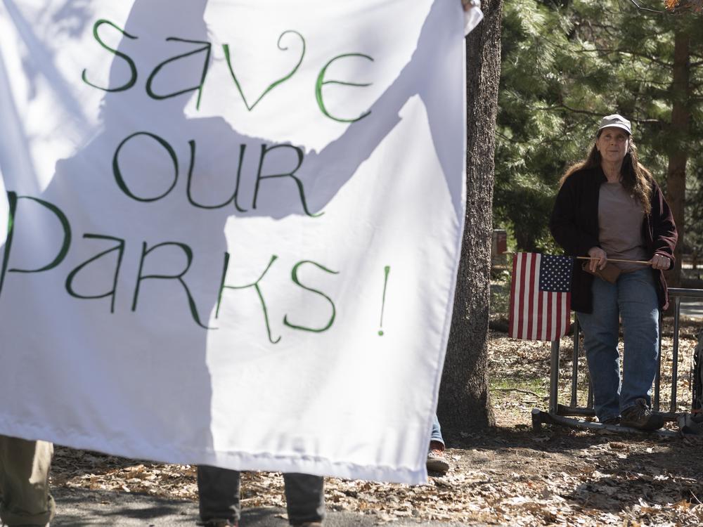 People demonstrate during a protest against federal employee layoffs at Yosemite National Park, California on March 1, 2025. Many workers at the U.S. Department of Interior and other agencies are being reinstated following court orders.