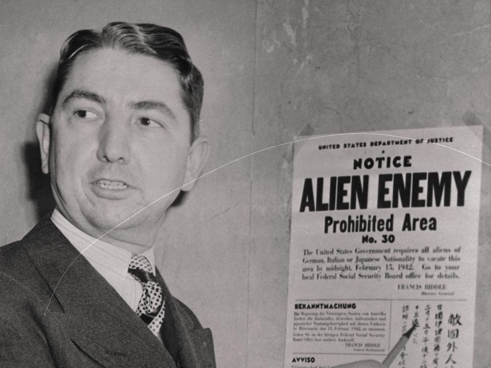 Tom C. Clark, coordinator of the Alien Enemy Control program of the Western Defense Command, points to the first warning card telling 